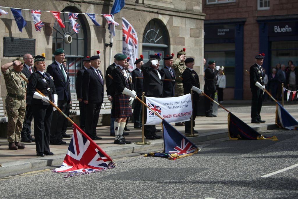 Courier News - ArmedForcesDay - FlagRaising - Forfar - Angus. Armed Forces Day. Town and County Hall. HM Lord Lieutenant, the Provost of Angus and past, present and future servicemen and women will muster behind the Town Hall on the north side and march, in order, a short distance to the south side at The Cross. The march will be coordinated by members of The Royal British Legion (Scotland) Forfar Branch and marching with Standard Bearers and Queens Colours following a lone Piper.  Once in position and at 10.30 the Bugler will sound at which point the commissioned AFD flag will be raised. Picture shows; the standards being lowered as part of the parade, Monday 20 June 2016.