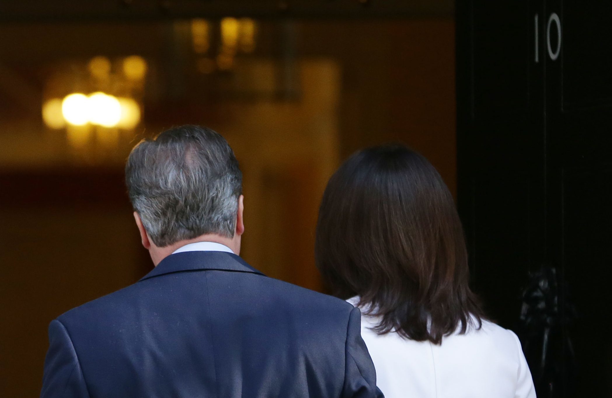 Prime Minister David Cameron heads back into Downing Street with wife Samantha after confirming his intention to resign.