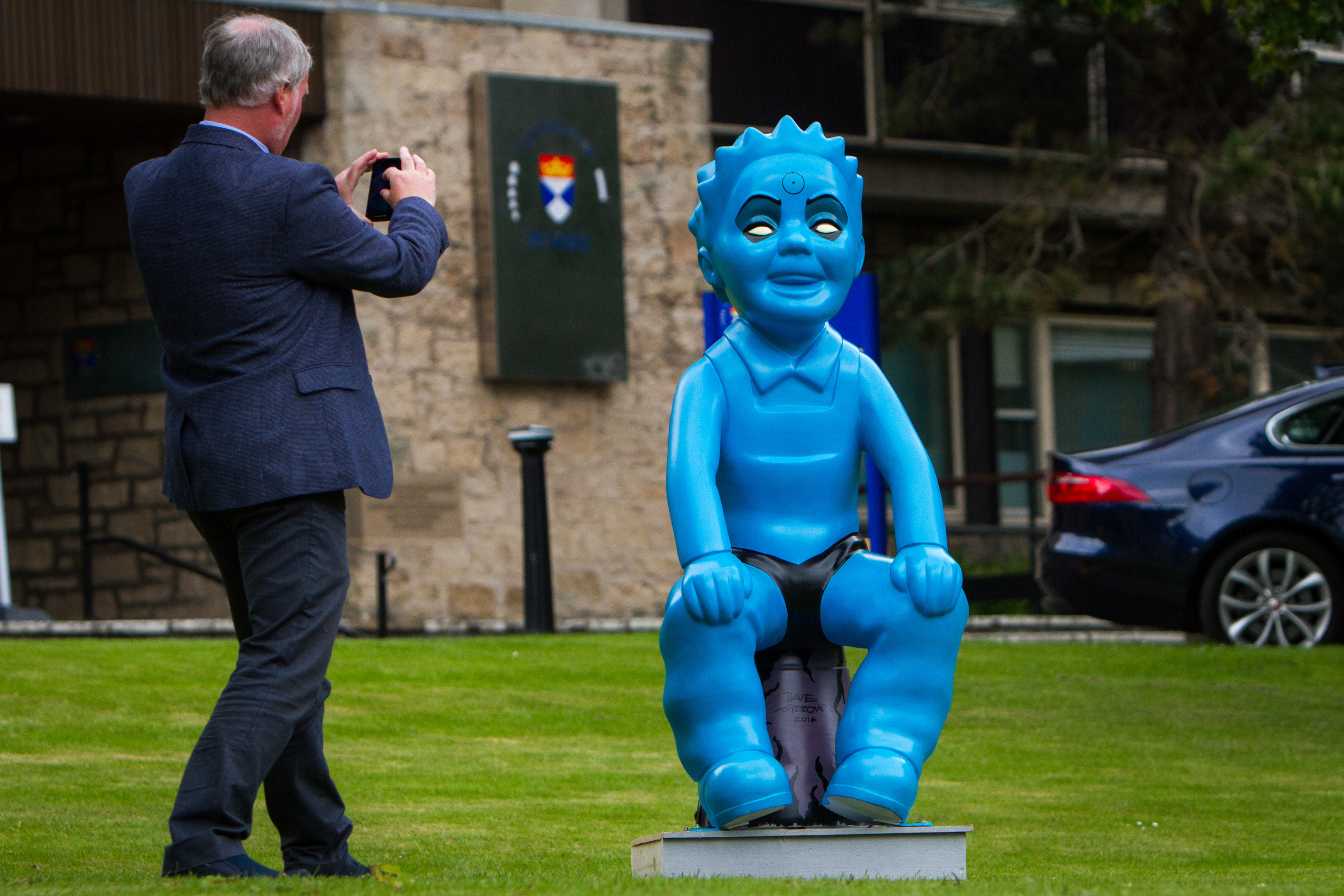 Shaun O'Reilly takes a picture of the statue.