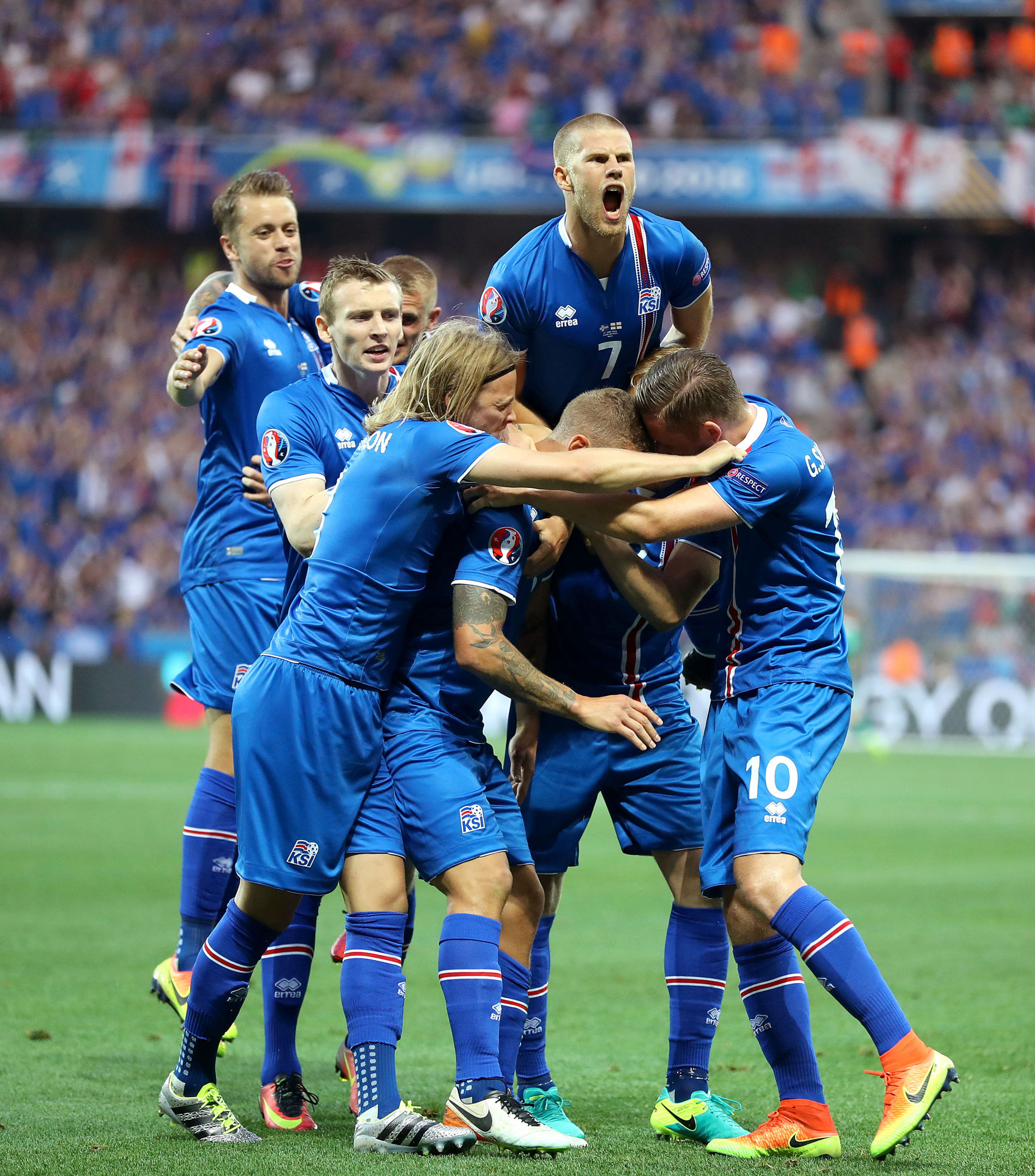 Iceland's Ragnar Sigurdsson (centre, partly hidden) is mobbed by his team-mates as he celebrates scoring his side's first goal during the Round of 16 match at Stade de Nice.