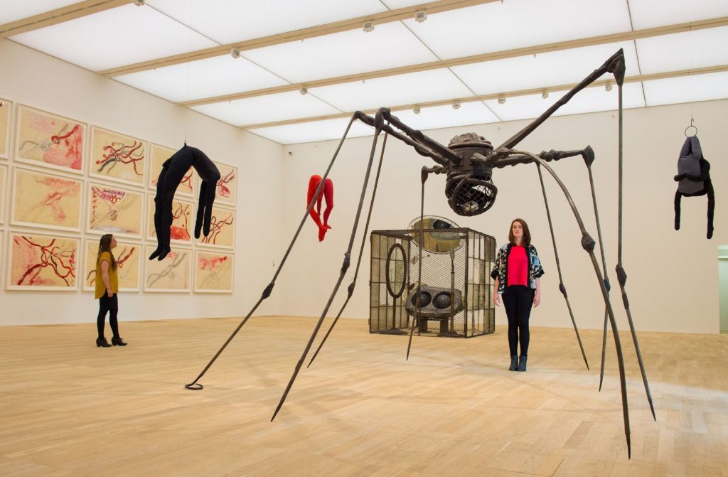 Photo of visitors viewing artworks including 'Spider' by Louise Bourgeois, one of the artworks on show in the new Switch House extension of the Tate Modern, in Southwark, London. 