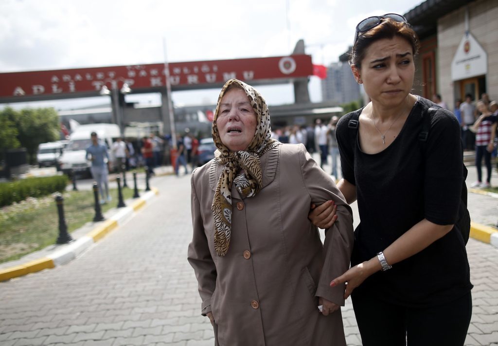 A family member helps Sacide Bugda, the mother of Abdulhakim Bugda, 24, one of victims, outside the Forensic Medical Center in Istanbul, Wednesday, June 29, 2016. Suicide attackers killed dozens and wounded more than 140 at Istanbul's busy Ataturk Airport late Tuesday, the latest in a series of bombings to strike Turkey in recent months. Turkish officials said the massacre was most likely the work of the Islamic State group. (AP Photo/Emrah Gurel) TURKEY OUT