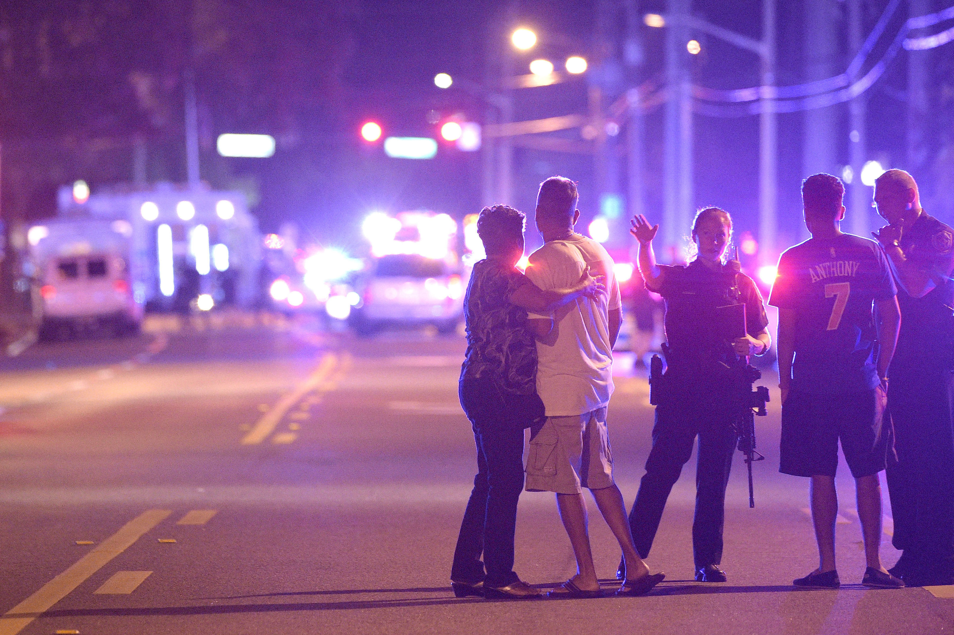 Orlando Police officers direct family members away from a multiple shooting at a nightclub in Orlando,.