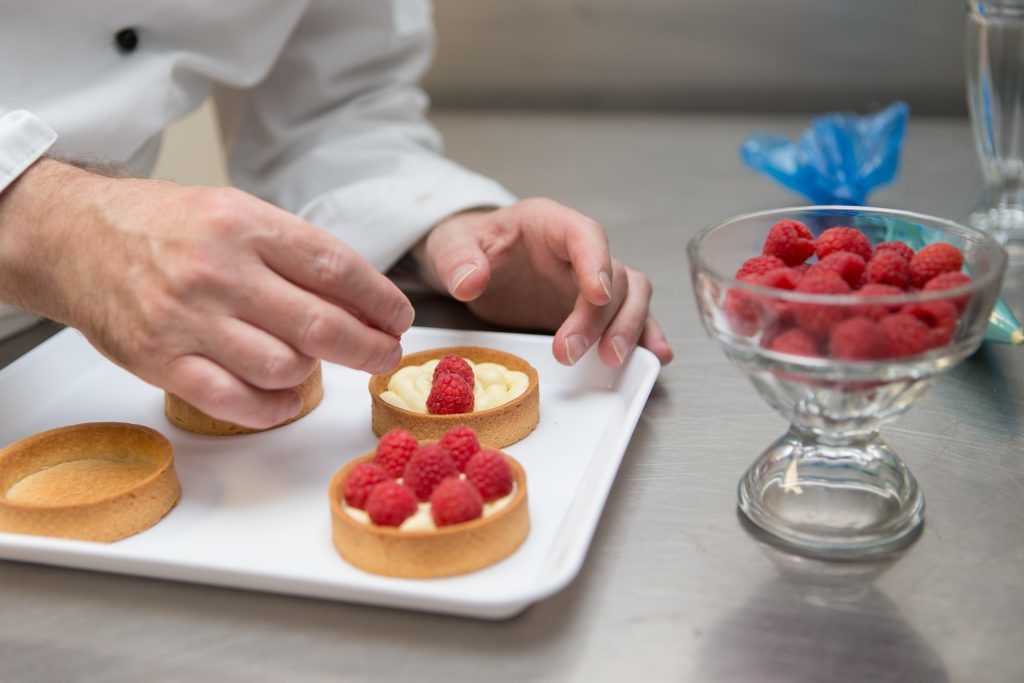 Kenny Hutton making strawberry tart, raspberry with Dark Chocloate Ganache Tart, Raspberry, Lime & White Chocolate Ganache and a Lemon Tart. All tarts are encased in a Vanilla Sable