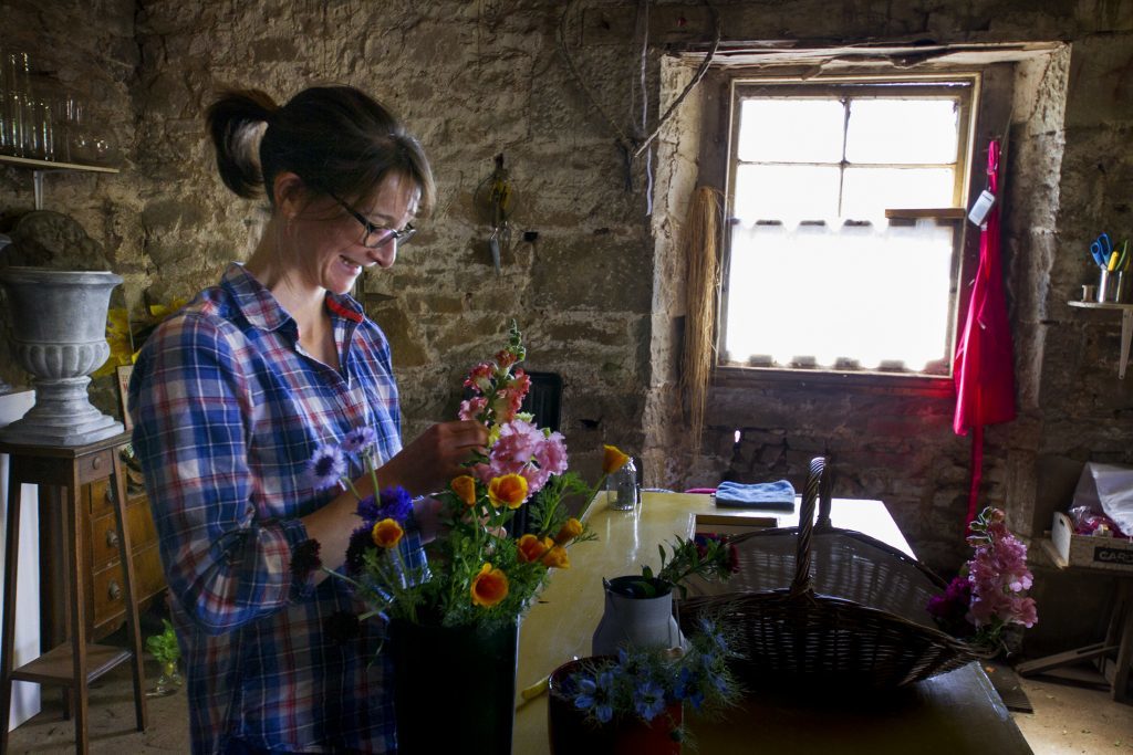 Kelly Orr arranges her cuttings in an old steading