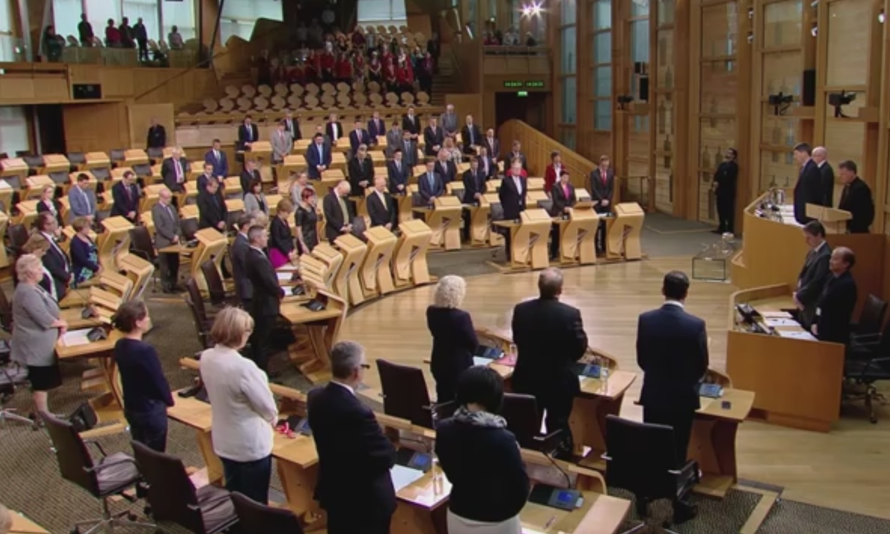 MSPs stand to observe a minute's silence in tribute to the victims of the Orlando shootings.