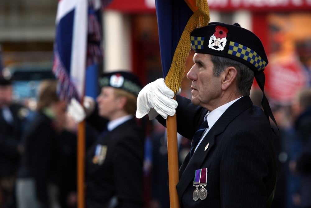Mr McKeown with the colours at Remembrance Day services in Forfar in 2010
