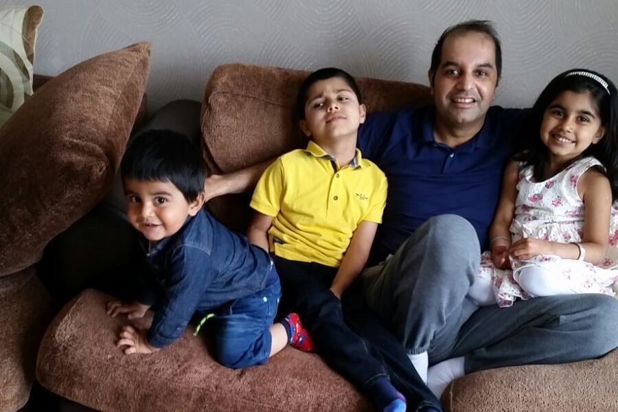 Mr Salam pictured at home with his children Arham, Arafat, and Aleena.
