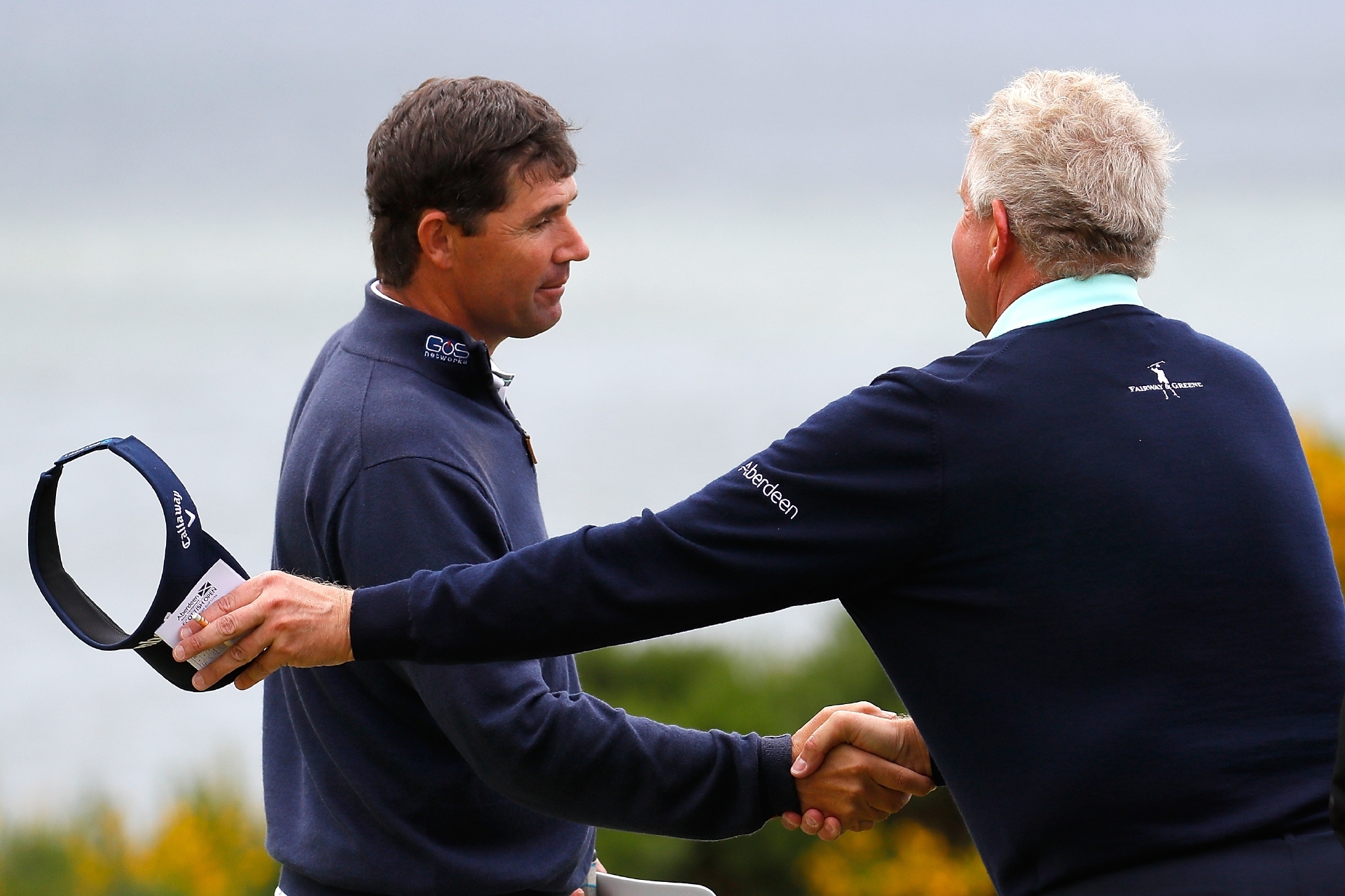 Old adversaries Padraig Harrington and Colin Montgomerie shake hands at the end of their second at Castle Stuart yesterday.