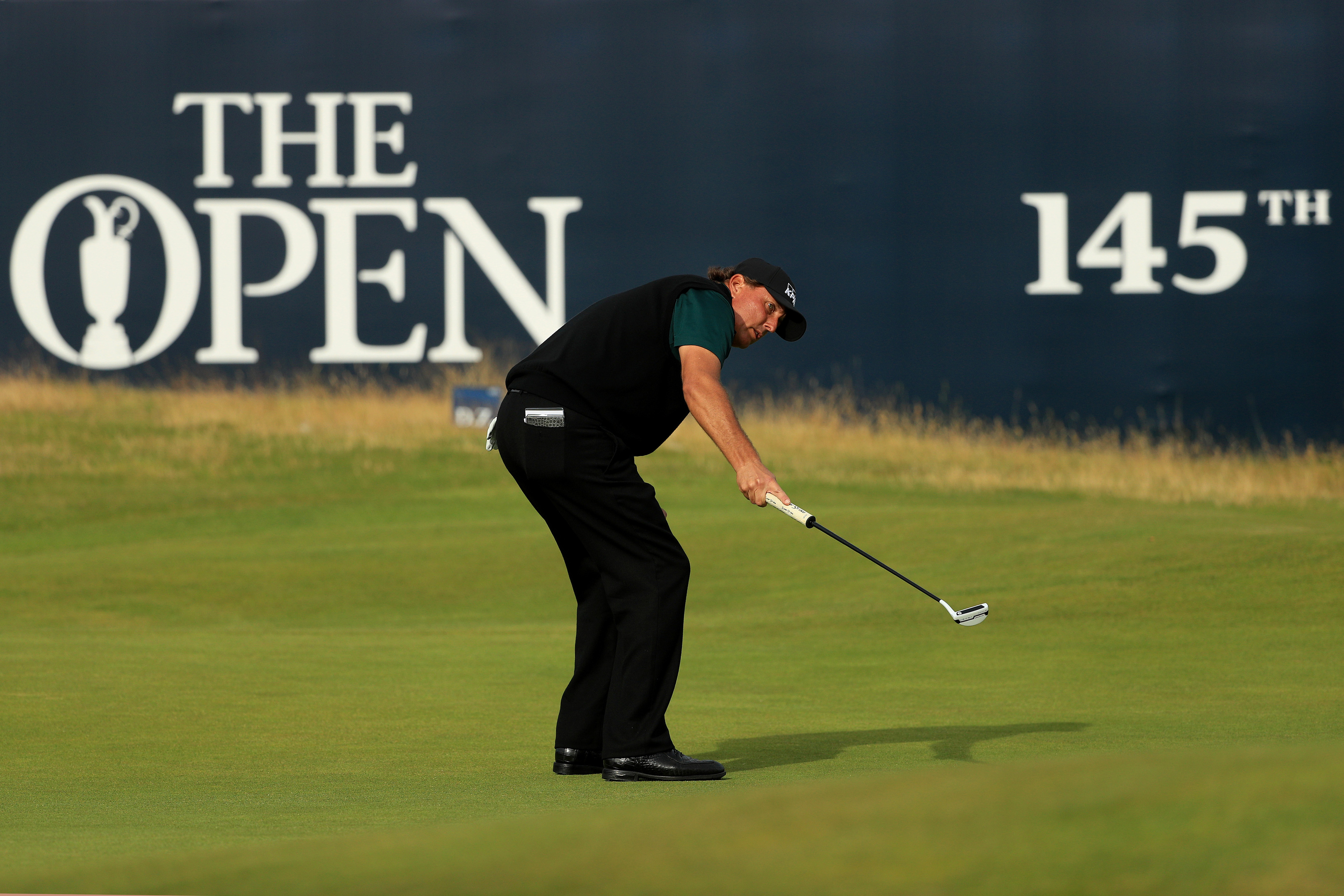 Phil Mickelson watches in disbelief as his putt for an historic 62 lips out on the 18th at Royal Troon.