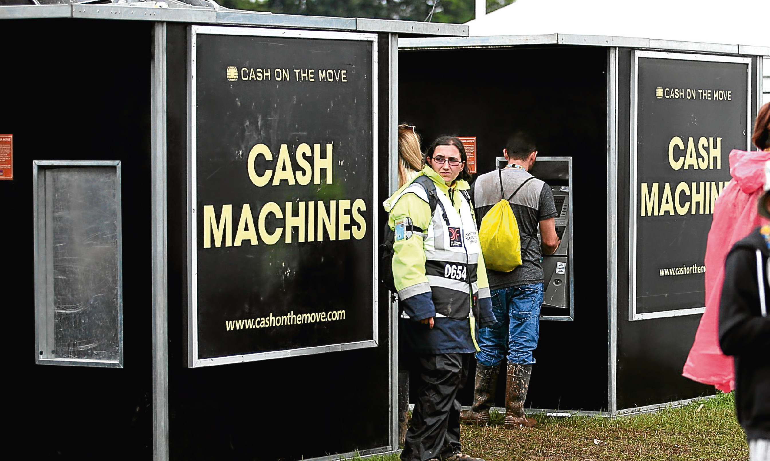 A security guard stands alongside cash machines, where one was stolen at T in the Park.