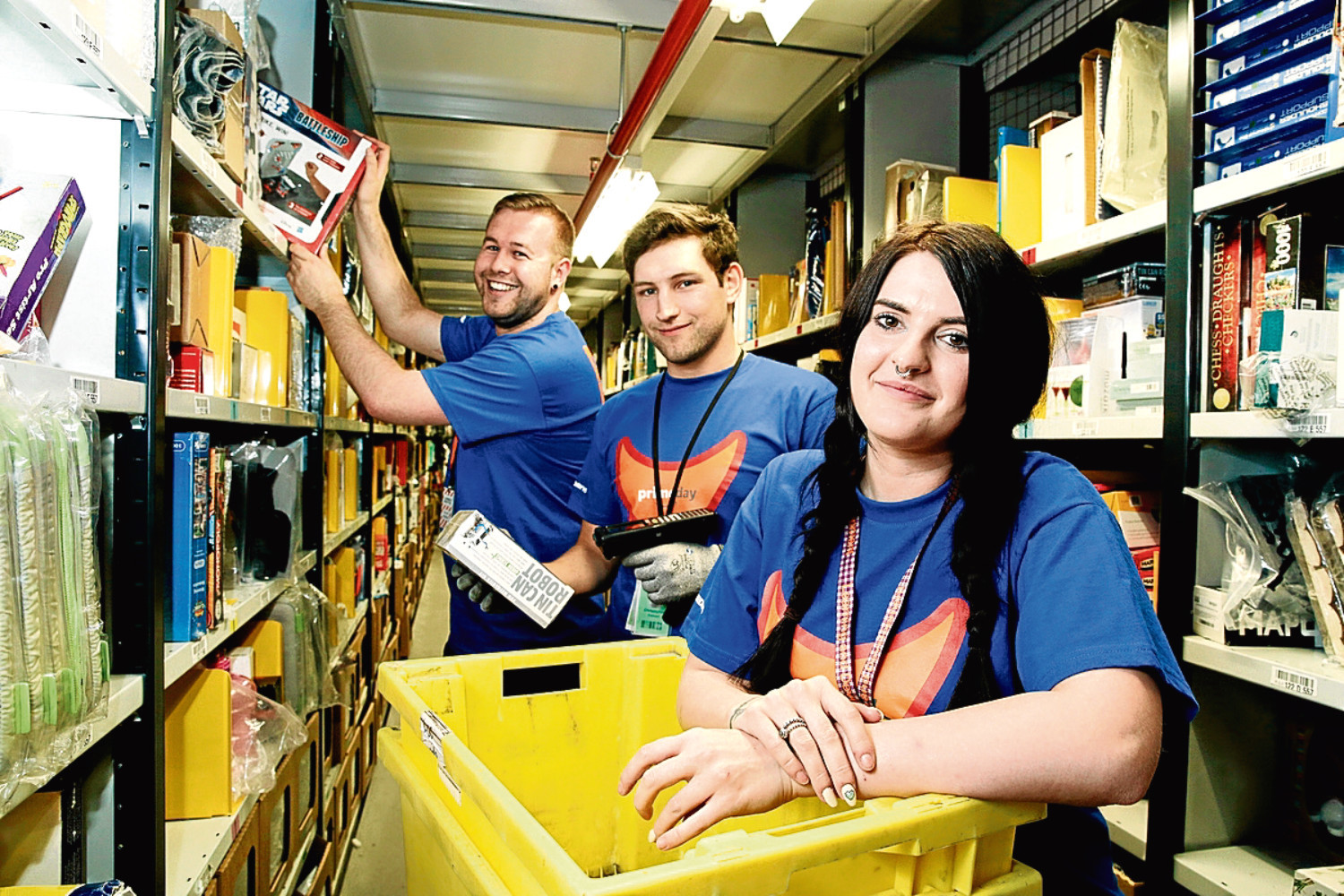 David Clunie, Chris Stewart and Paige Crosbie picking orders at Amazon's Dunfermline fulfilment centre