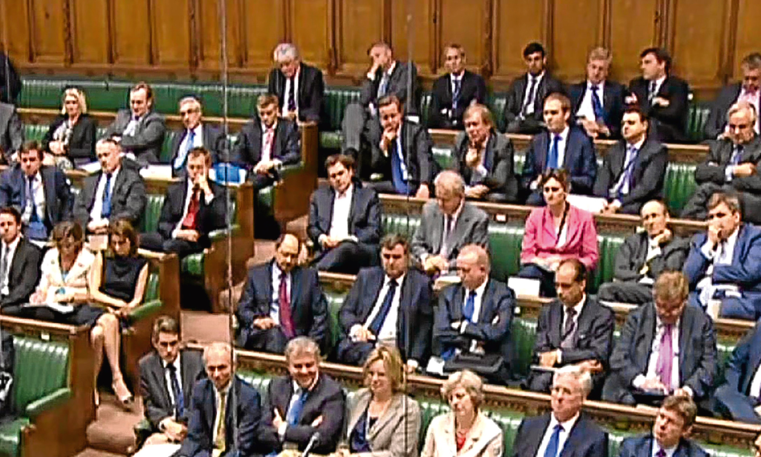 Just another backbencher. David Cameron, centre with his head resting on his hand, watches the Trident debate in the Commons from afar.
