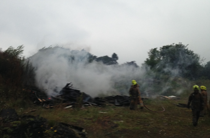 Fire fighters controlled the large wood fire, but are unclear as to how it began.