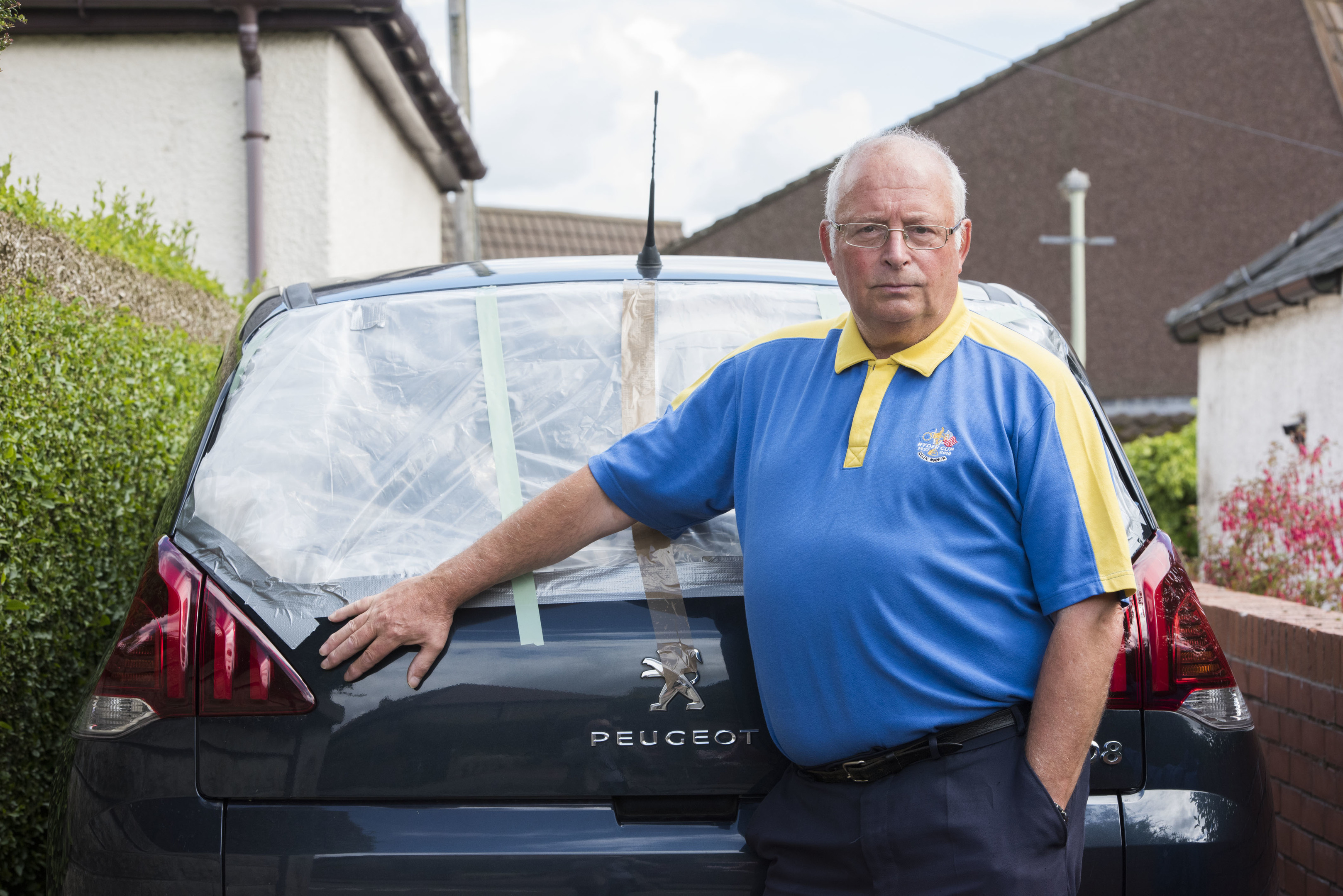 Douglas Fisher with his damaged car. Photo by Alan Richardson.