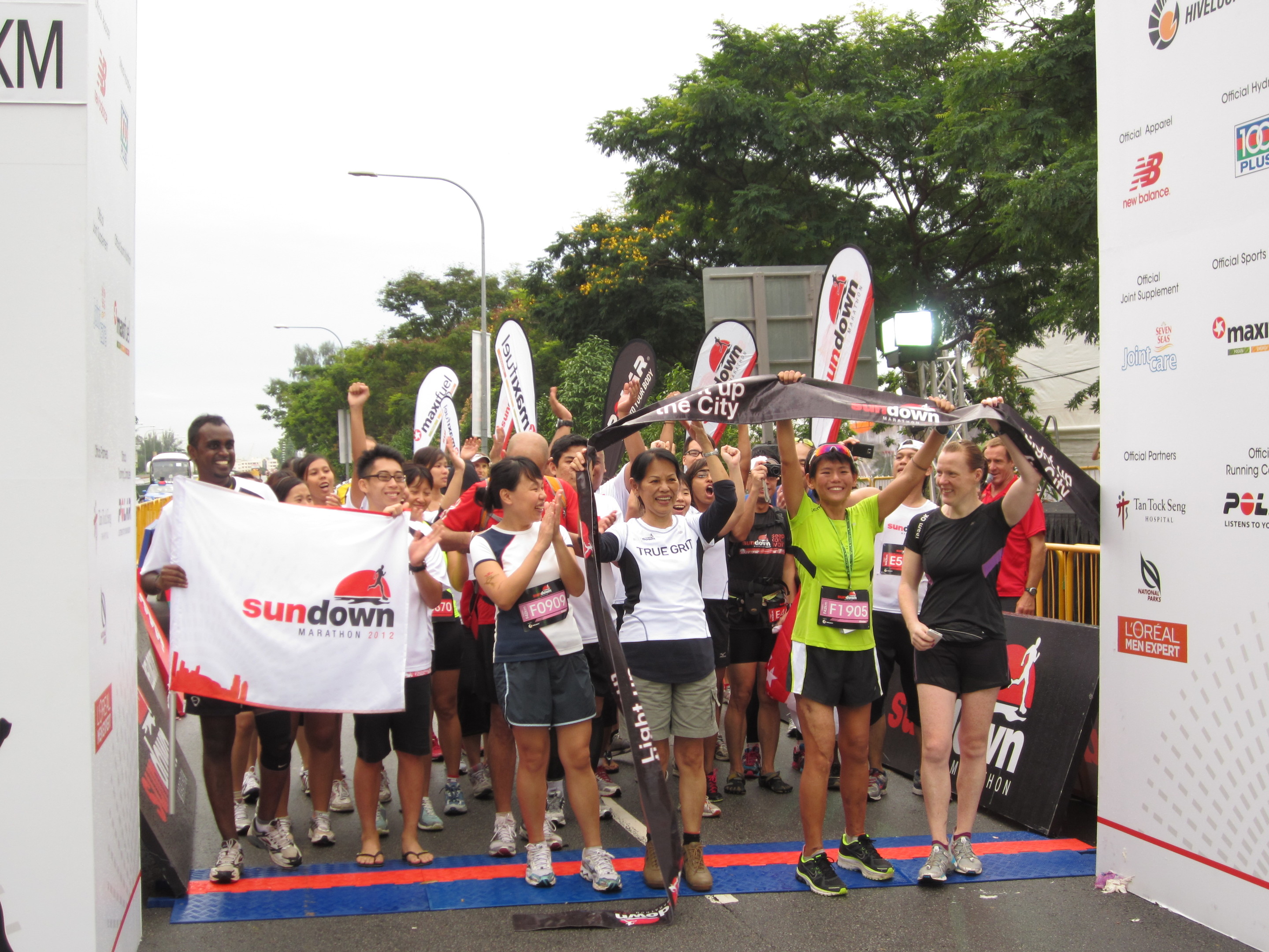 Kirsten (in green T-shirt, second right) and Orla (far right) celebrate the end of Kirsten’s first ‘race’ after her accident: the Singapore Sundown Marathon in 2012, which took her 10 ½ hours to walk.