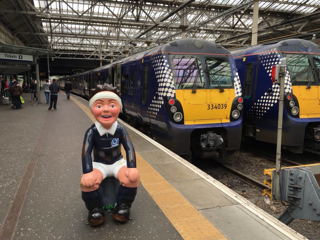 Wullie takes a closer look at the trains - but is careful not to overstep the yellow lines.