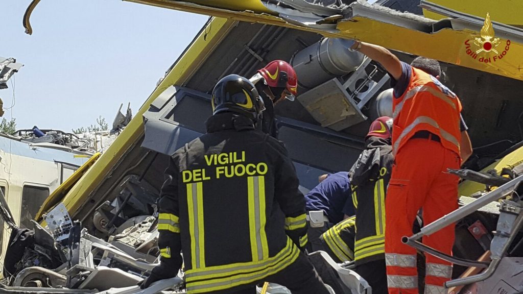 Italian firefighters  inspect the wreckage.