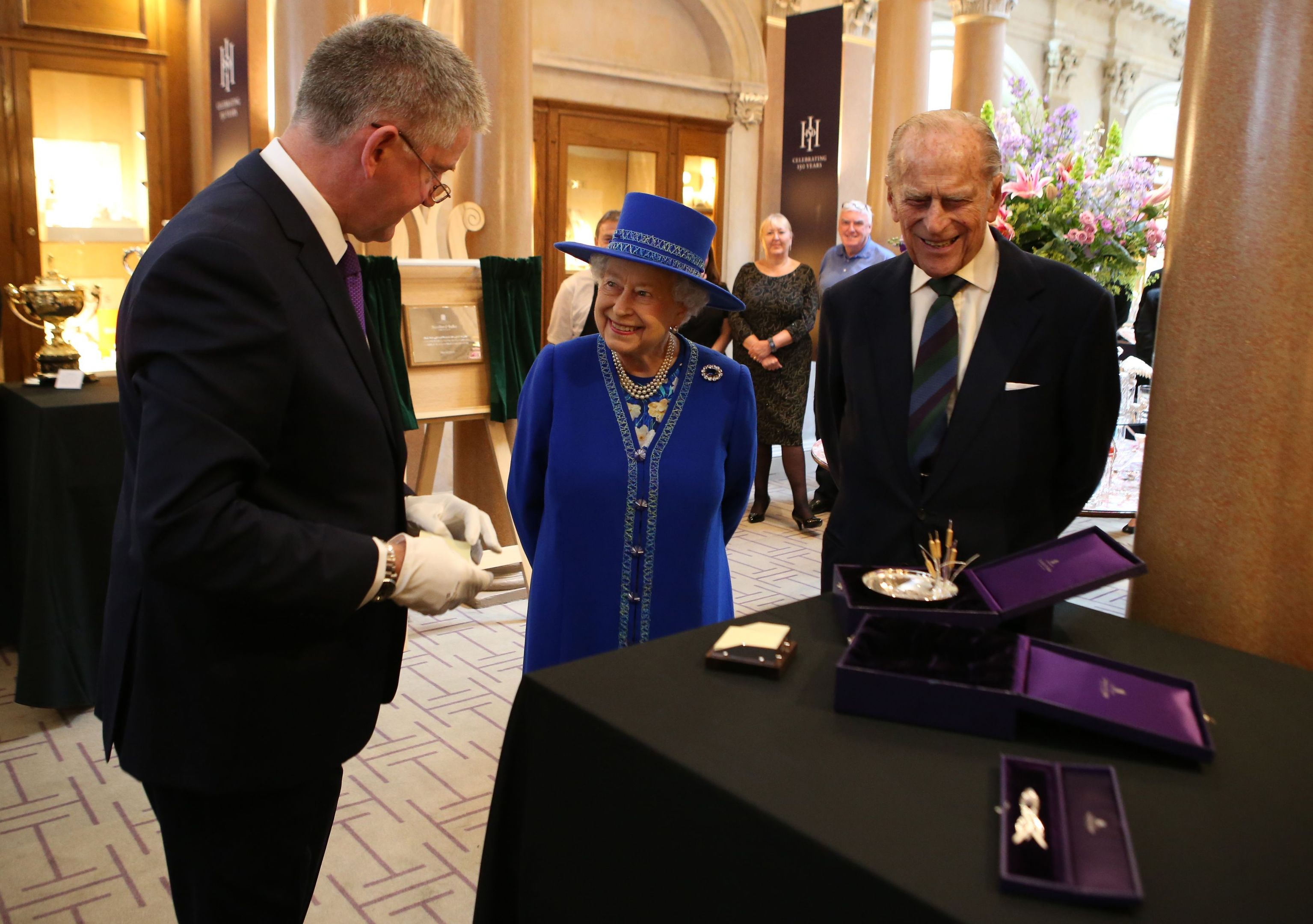 The Queen and the Duke of Edinburgh are presented with gifts by Chief Executive Stephen Paterson.
