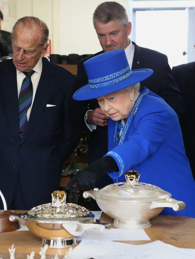 Queen Elizabeth II and the Duke of Edinburgh view the Queens Cup which is presented at the Calcutta  Races in India, during a visit to Hamilton and Inches jewellers in Edinburgh where they viewed a display of artefacts and met craftsmen, including some who are part of the Queen Elizabeth Scholarship Trust founded to allow promising young people develop their skills by working with masters of their craft. PRESS ASSOCIATION Photo. Picture date: Friday July 8, 2016. See PA story ROYAL Queen. Photo credit should read: Andrew Milligan/PA Wire