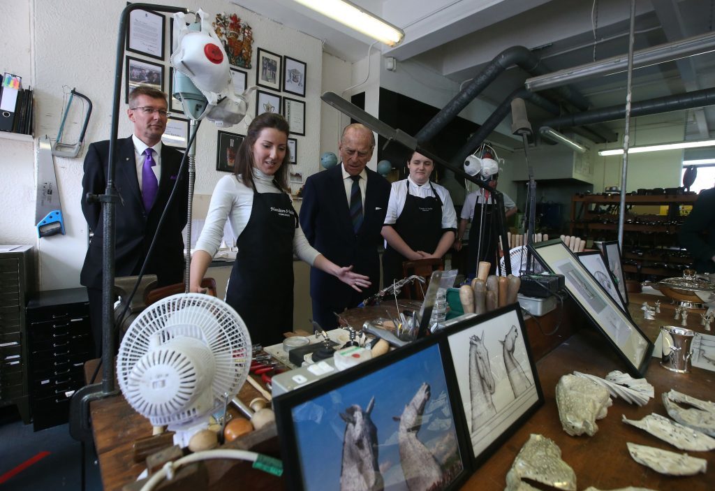 The Duke of Edinburgh in the Silversmiths workshop during a visit to Hamilton and Inches jewellers in Edinburgh with Queen Elizabeth II, where they viewed a display of artefacts and met craftsmen, including some who are part of the Queen Elizabeth Scholarship Trust founded to allow promising young people develop their skills by working with masters of their craft. PRESS ASSOCIATION Photo. Picture date: Friday July 8, 2016. See PA story ROYAL Queen. Photo credit should read: Andrew Milligan/PA Wire