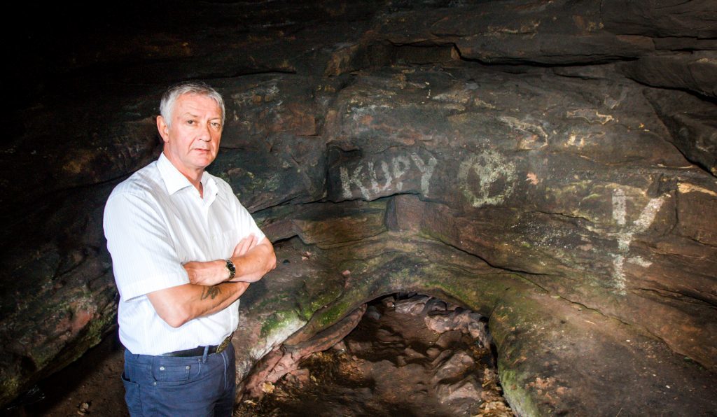 Councillor Tom Adams inspects some Wemyss Caves vandalism