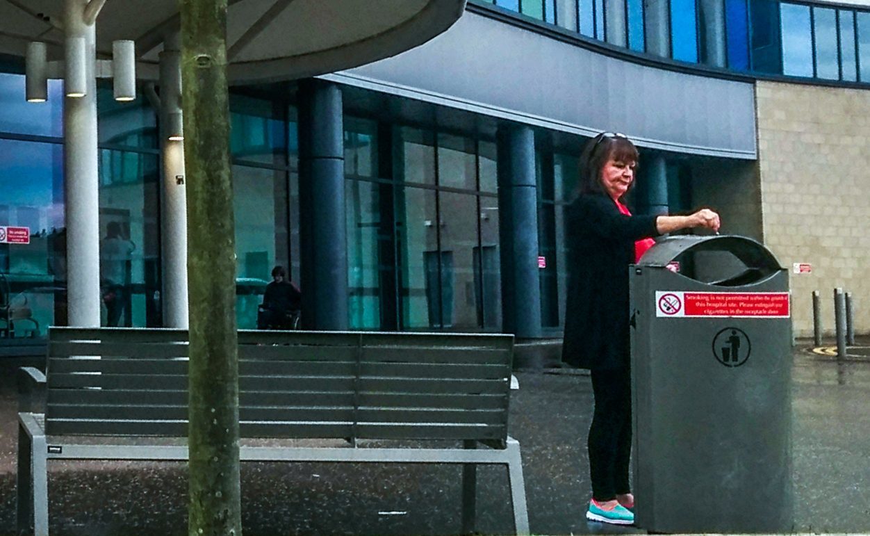 Smokers defy no-smoking signs at entrance to Victoria Hospital, Kirkcaldy