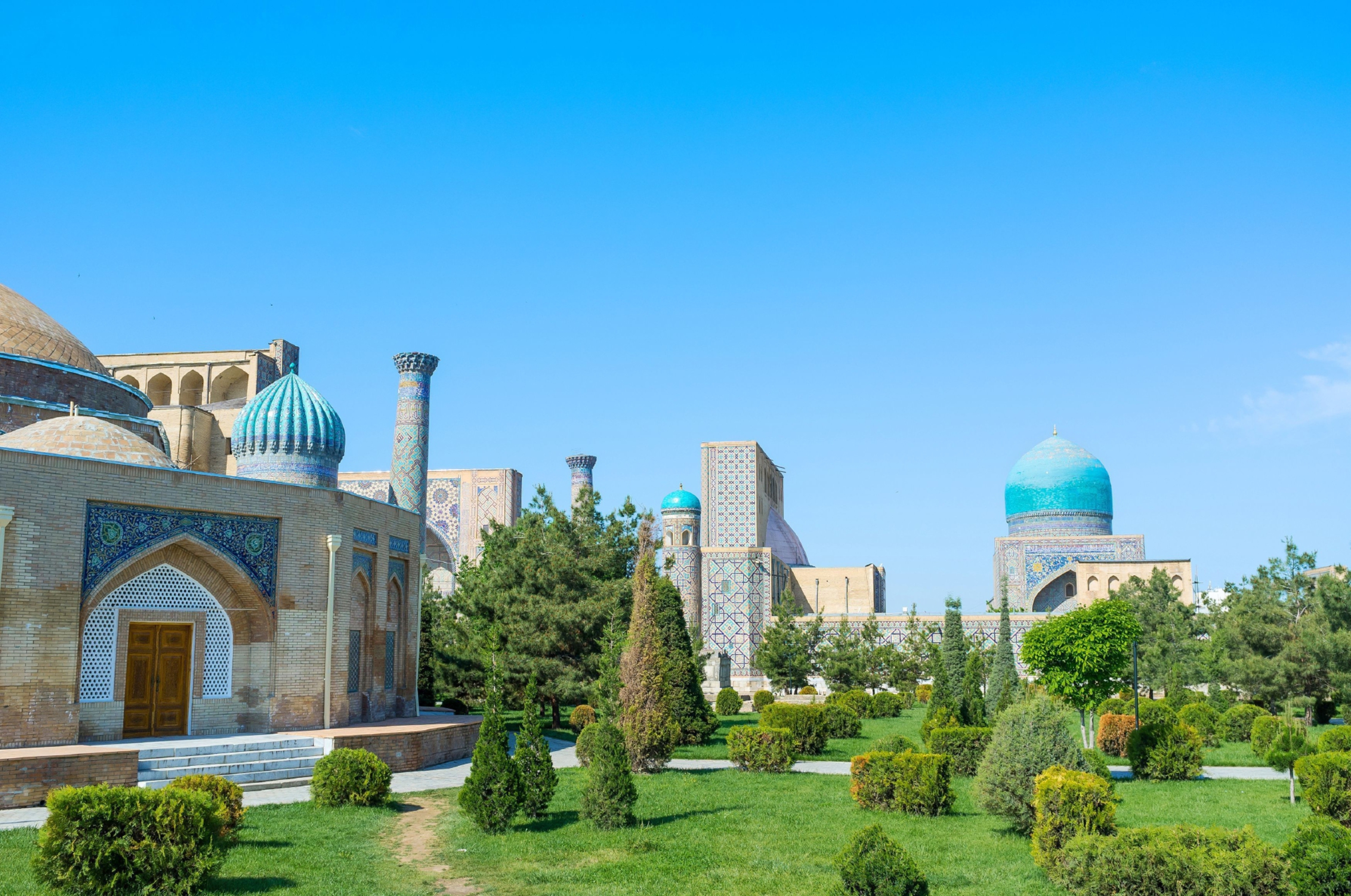 The old square of Registan and Chorsu trading dome surrounded by the lush garden, Samarkand, Uzbekistan.