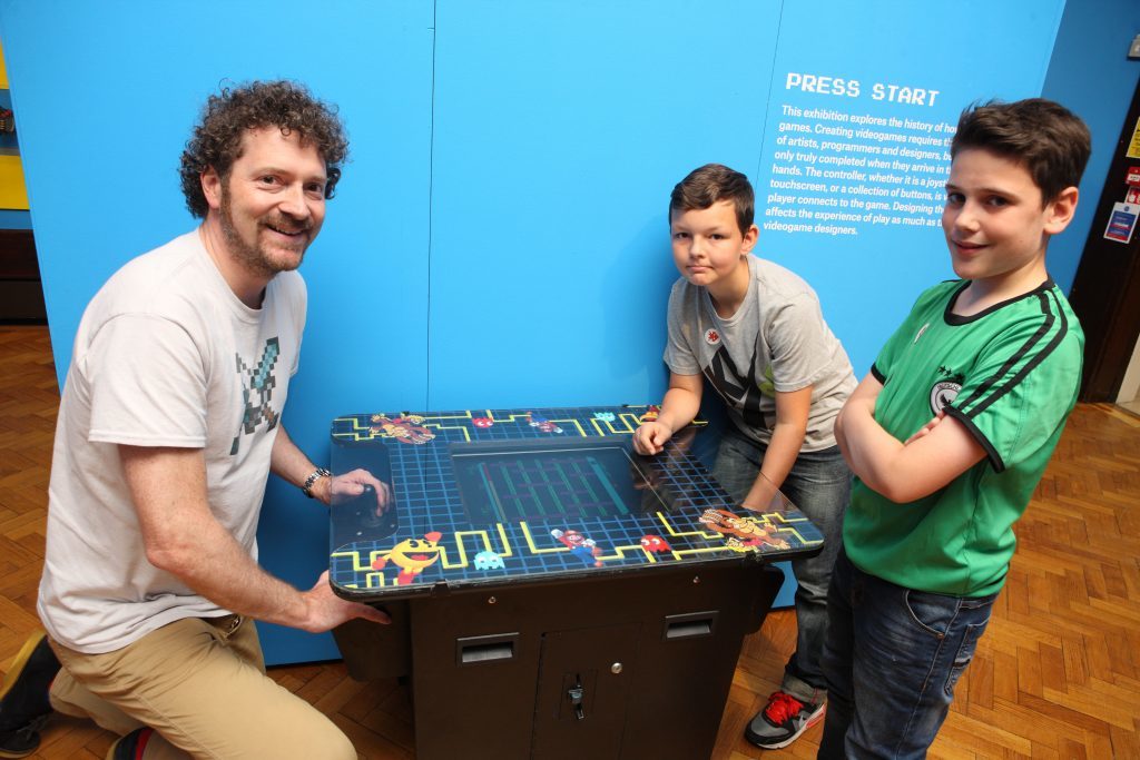 Chris van der Kuyl , at Perth Museum with Bruno Nowrotek and Sam Duncan, play an 80 eras video game 