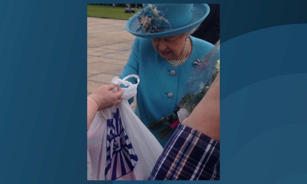 The Queen receives her unusual gift during Wednesday's royal event at Slessor Gardens in Dundee.