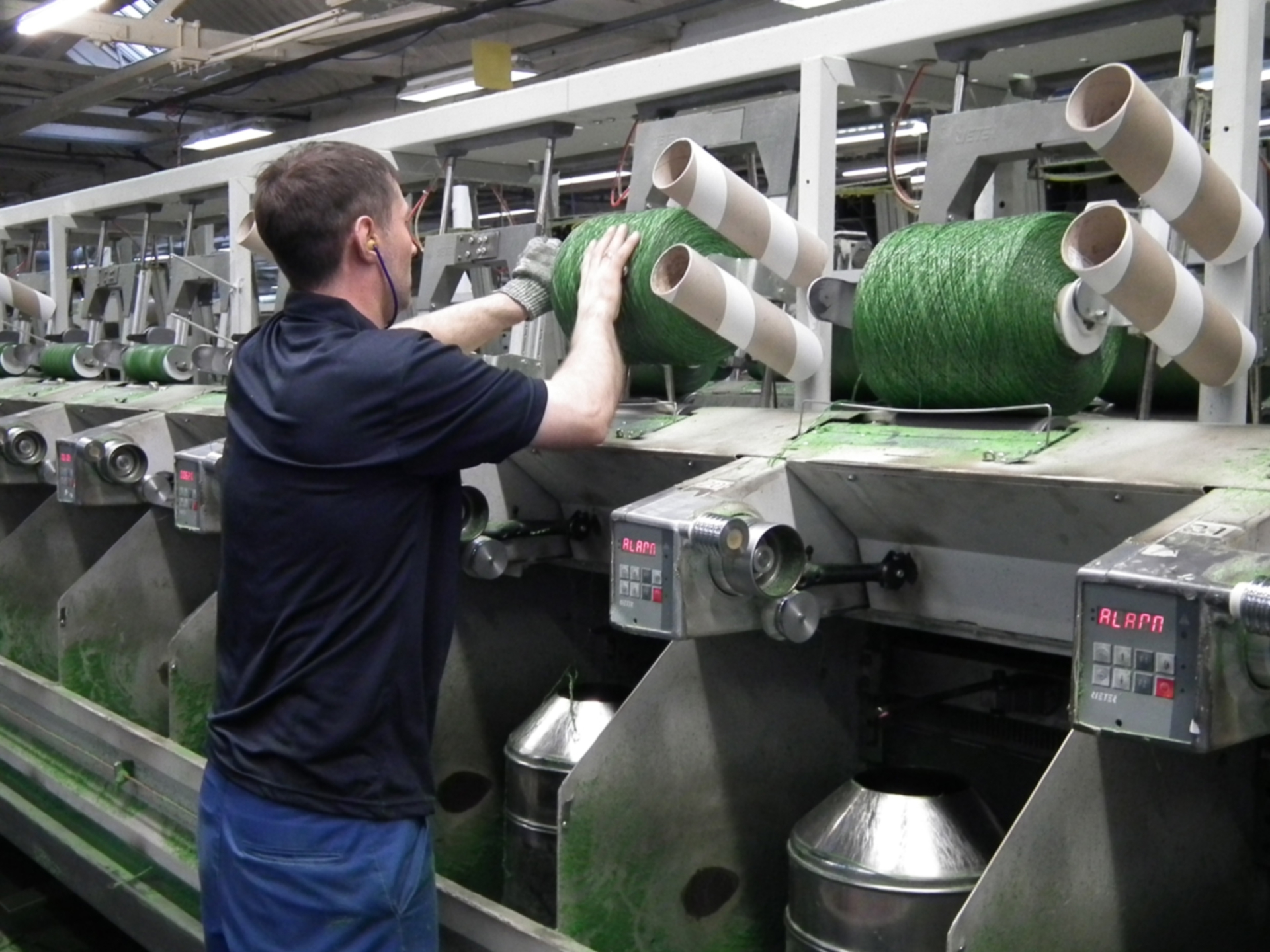 An employee at work in the premises of Low & Bonar, Dundee.