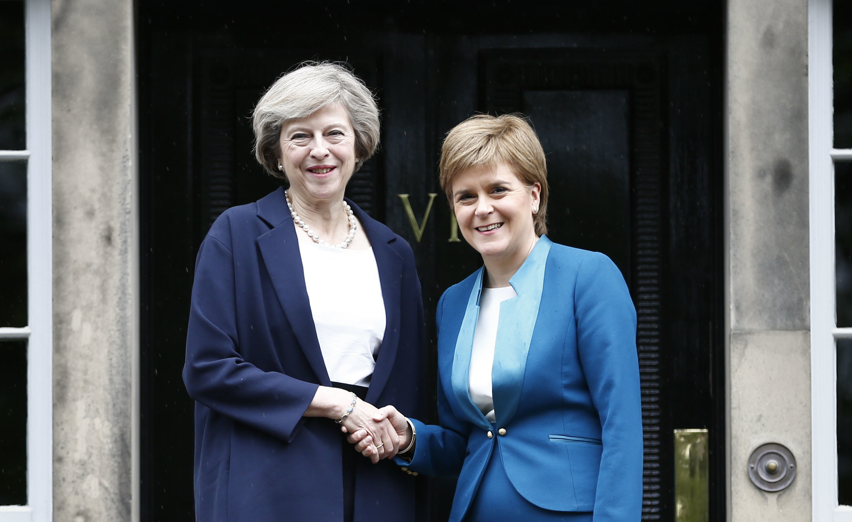 Theresa May meets Nicola Sturgeon outside Bute House.