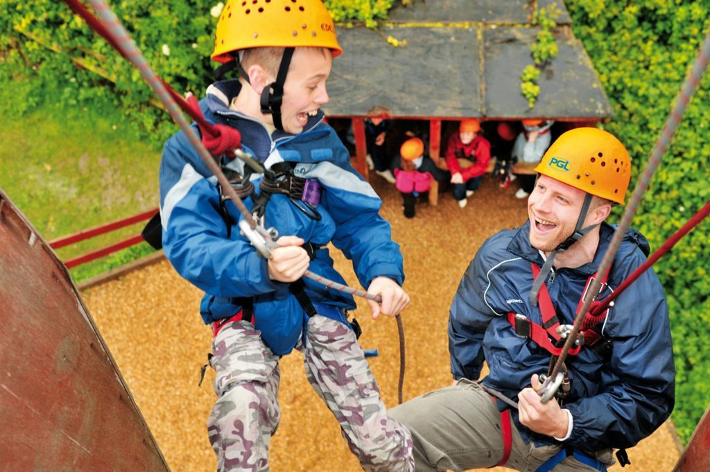 Family abseiling at PGL in Liddington, Wiltshire.