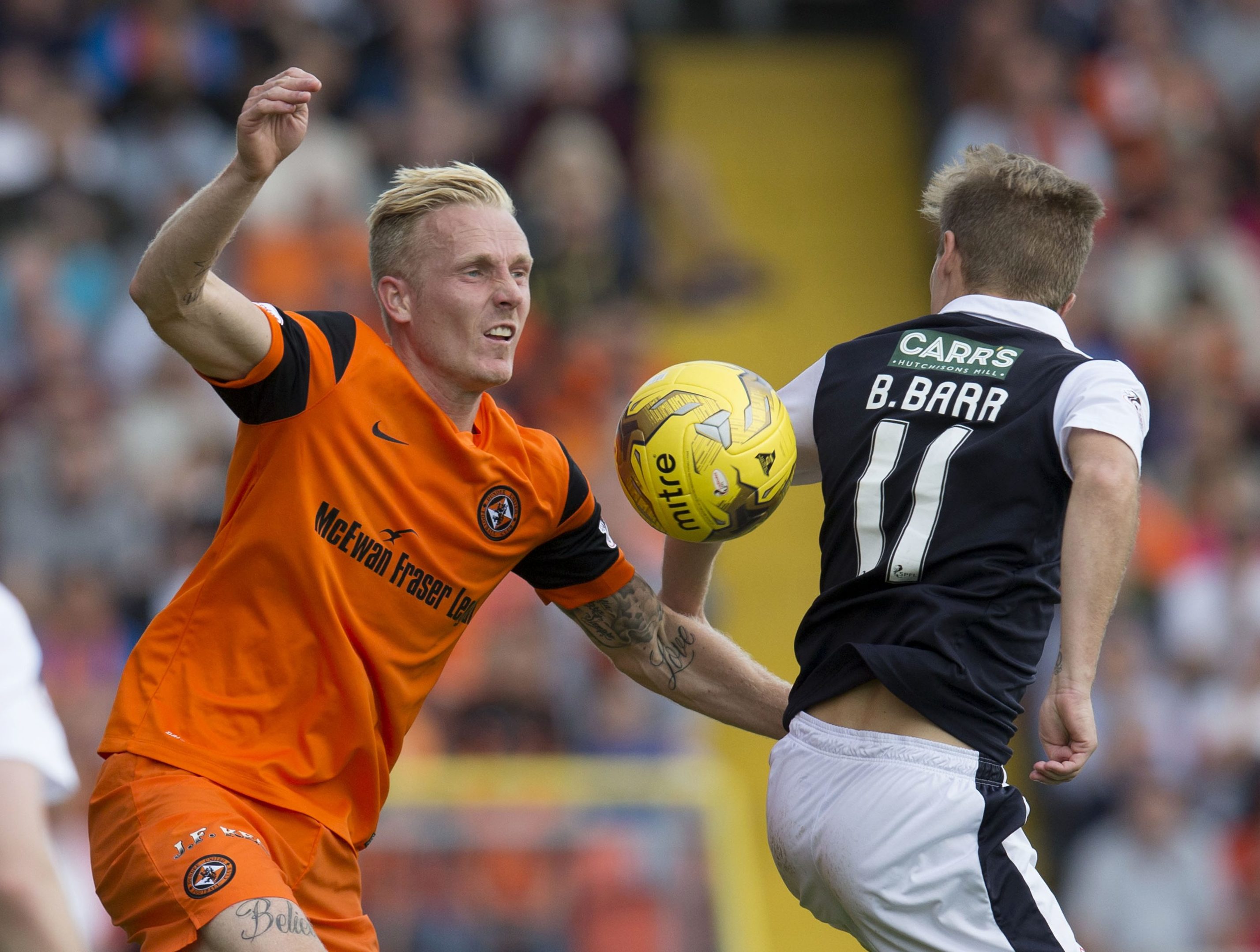 Dundee United's Nick van der Velden challenges Raith's Bobby Barr.