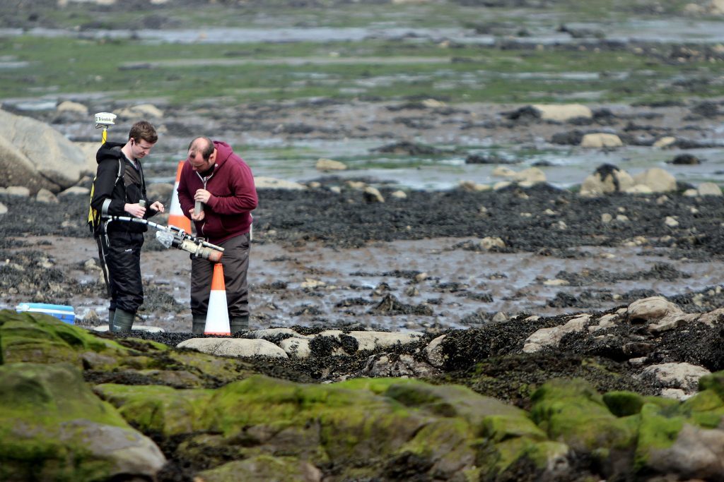 Workers from AMEC checking for radioactive particles.