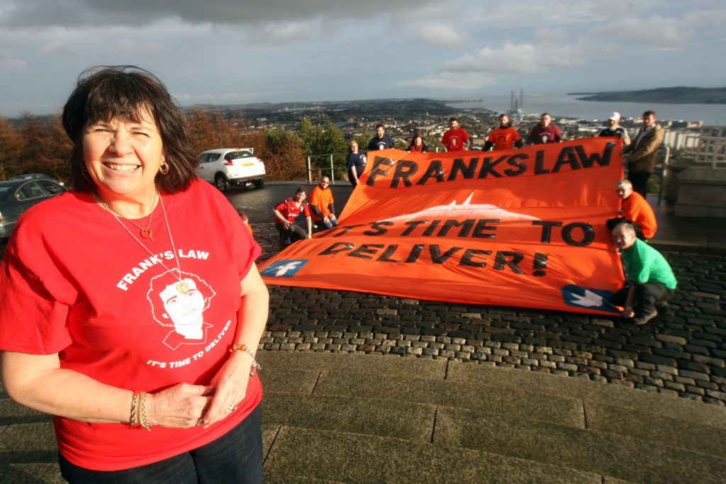 At the top of The Law, Dundee where football fans gathered with Amanda Kopel to unveil a Frank's Law banner.