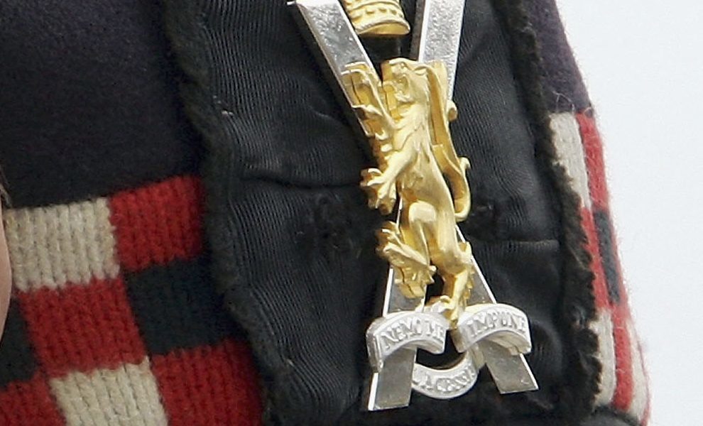 A Royal Regiment of Scotland cap badge.
