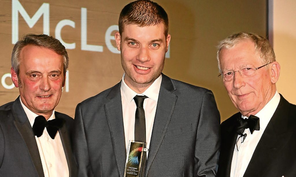 2015 Apprentice of the Year Alastair McLean with D&A College principal Grant Ritchie and Courier Business Awards host Nick Hewer.