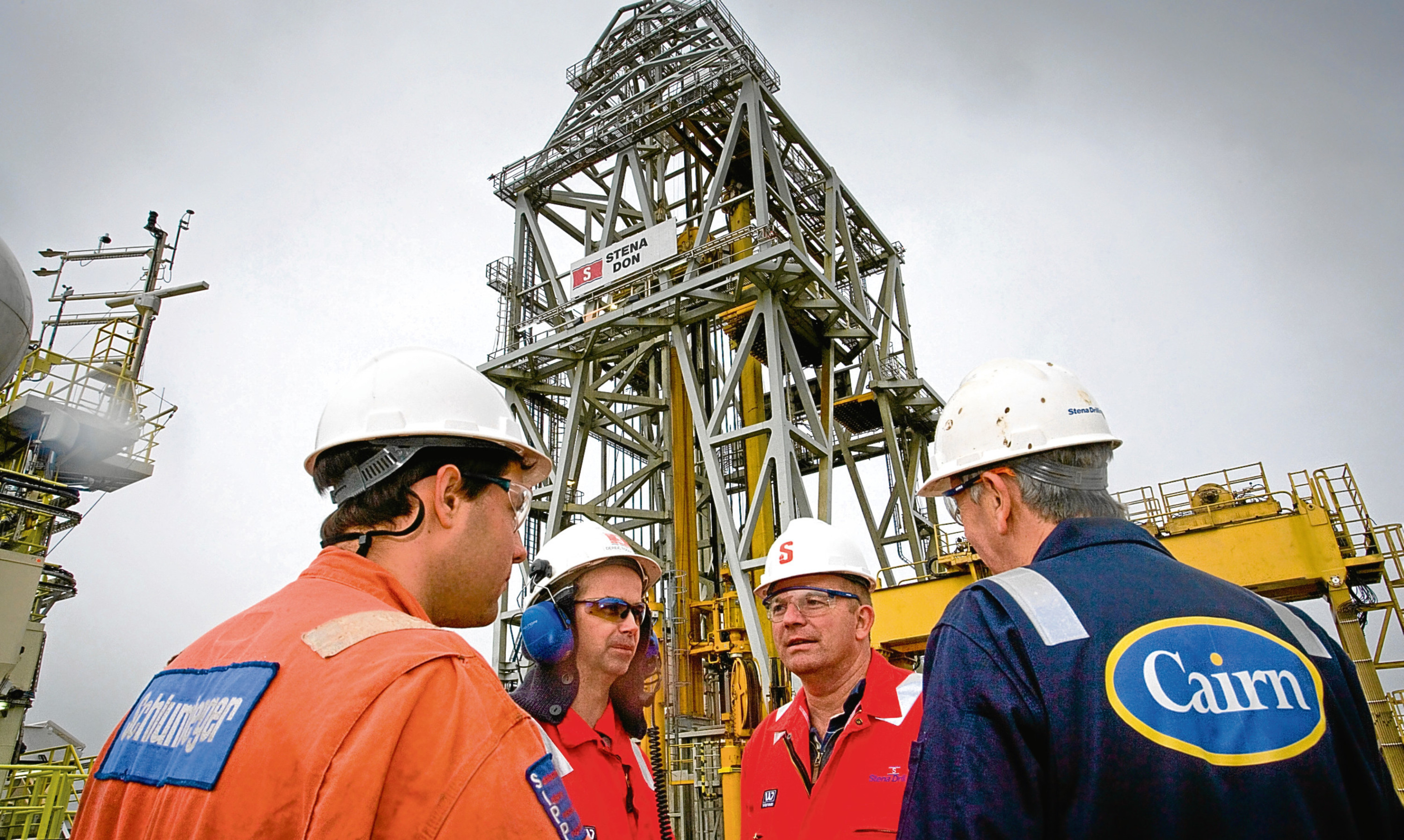 A Cairn technician in discussion with industry colleagues