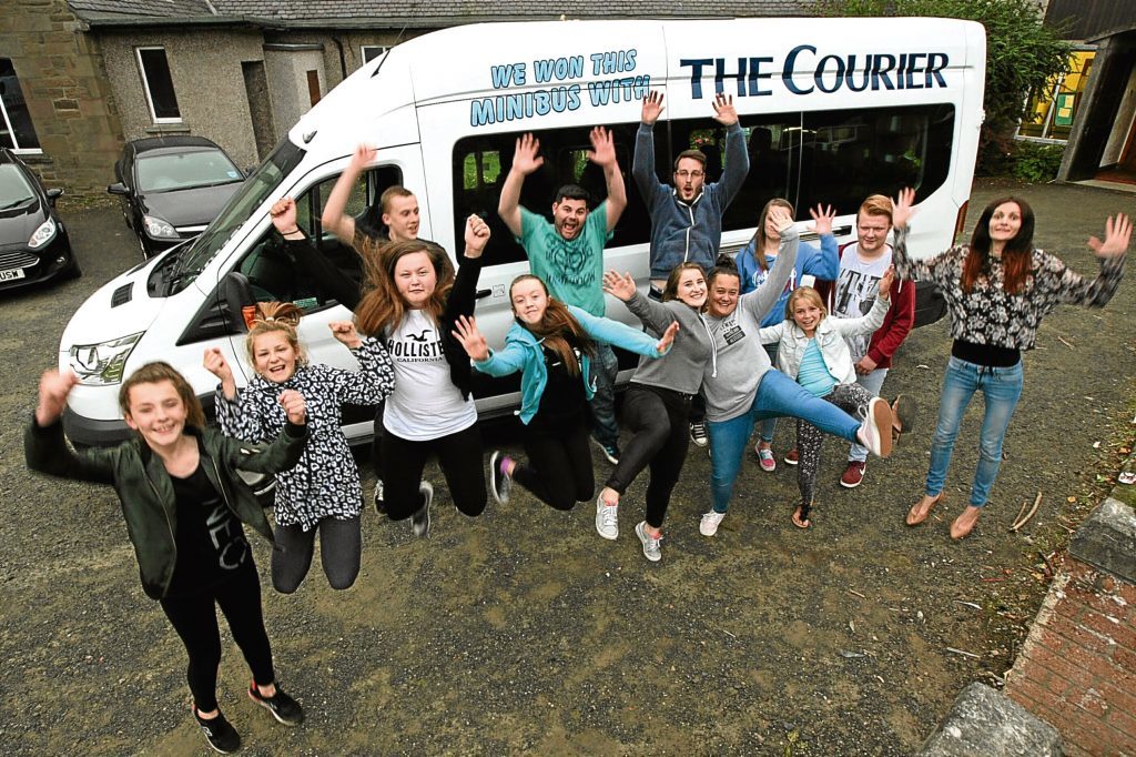 Happy travellers: the RockSolid Youth Project in Douglas with the minibus they won from The Courier.