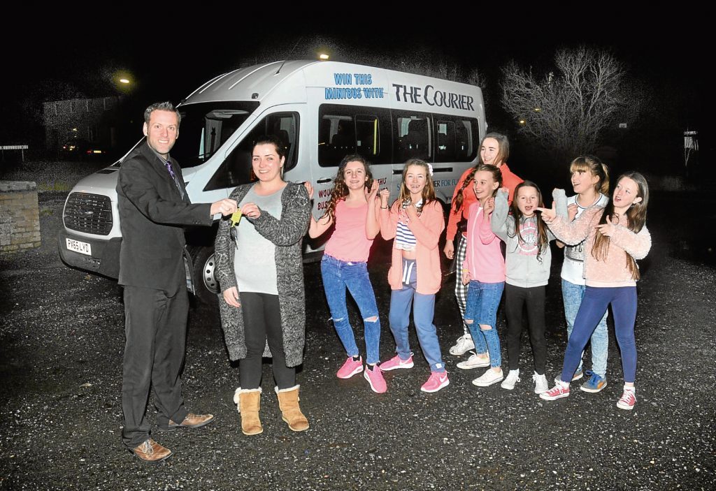 Courier assistant editor Dave Lord hands over the keys for the minibus to the RockSolid project.