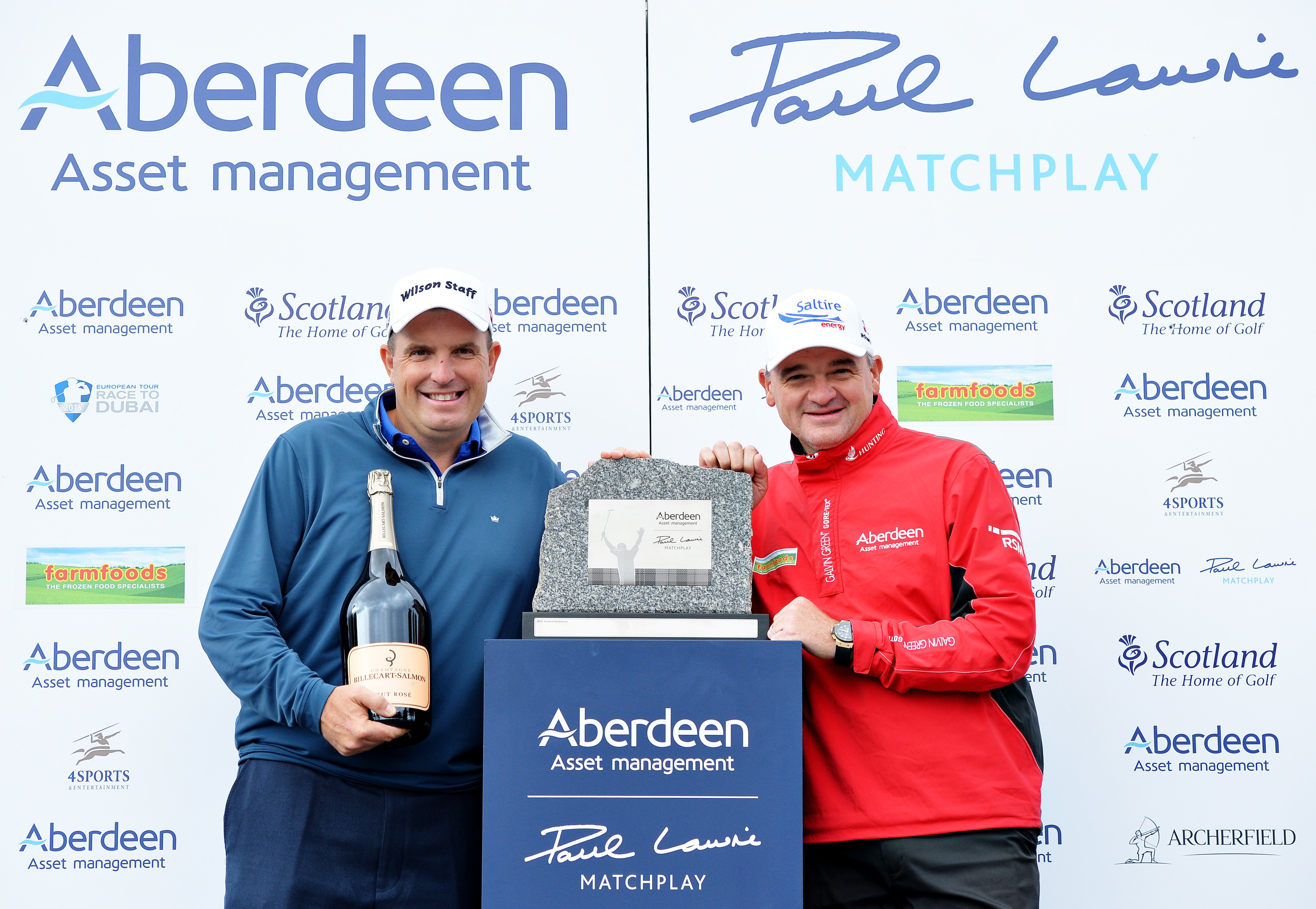 Anthony Wall accepts the trophy from host Paul Lawrie after winning at Archerfield.