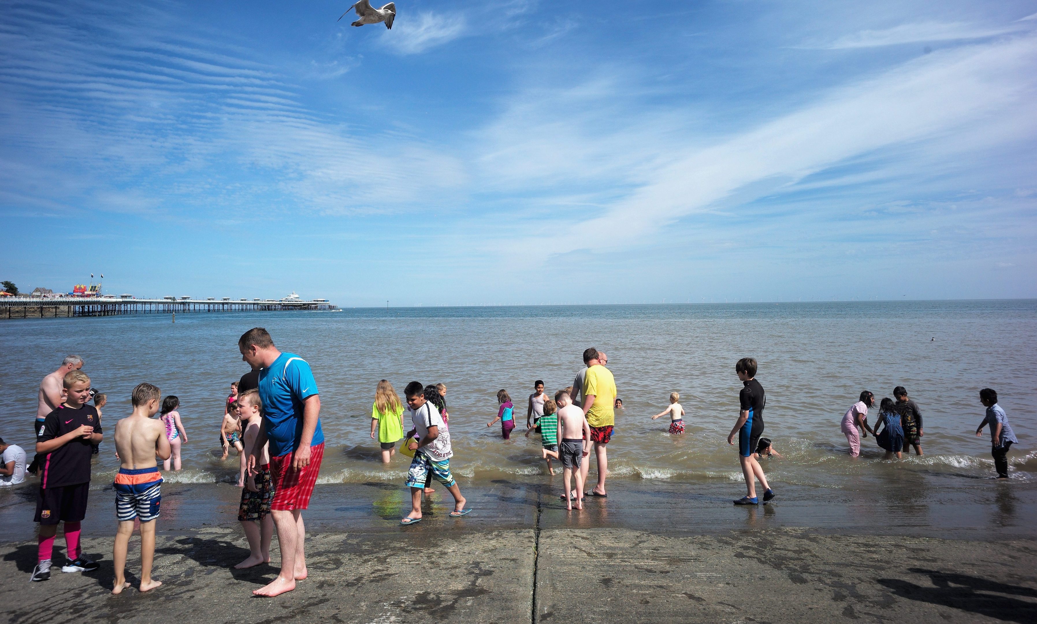 Holidaymakers cool off in the sea as they enjoy the hot weather on the North Wales coast at Llandudno.