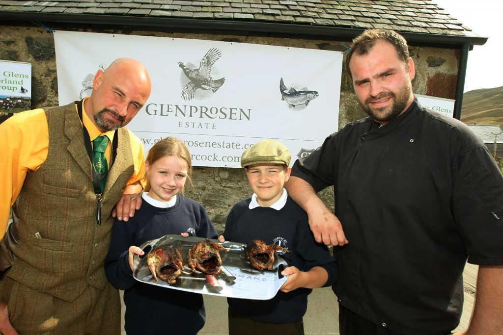 Bruce Cooper and Jordan Sinclair of Sinclair Catering with two pupils and the finished product, a barbecued grouse.