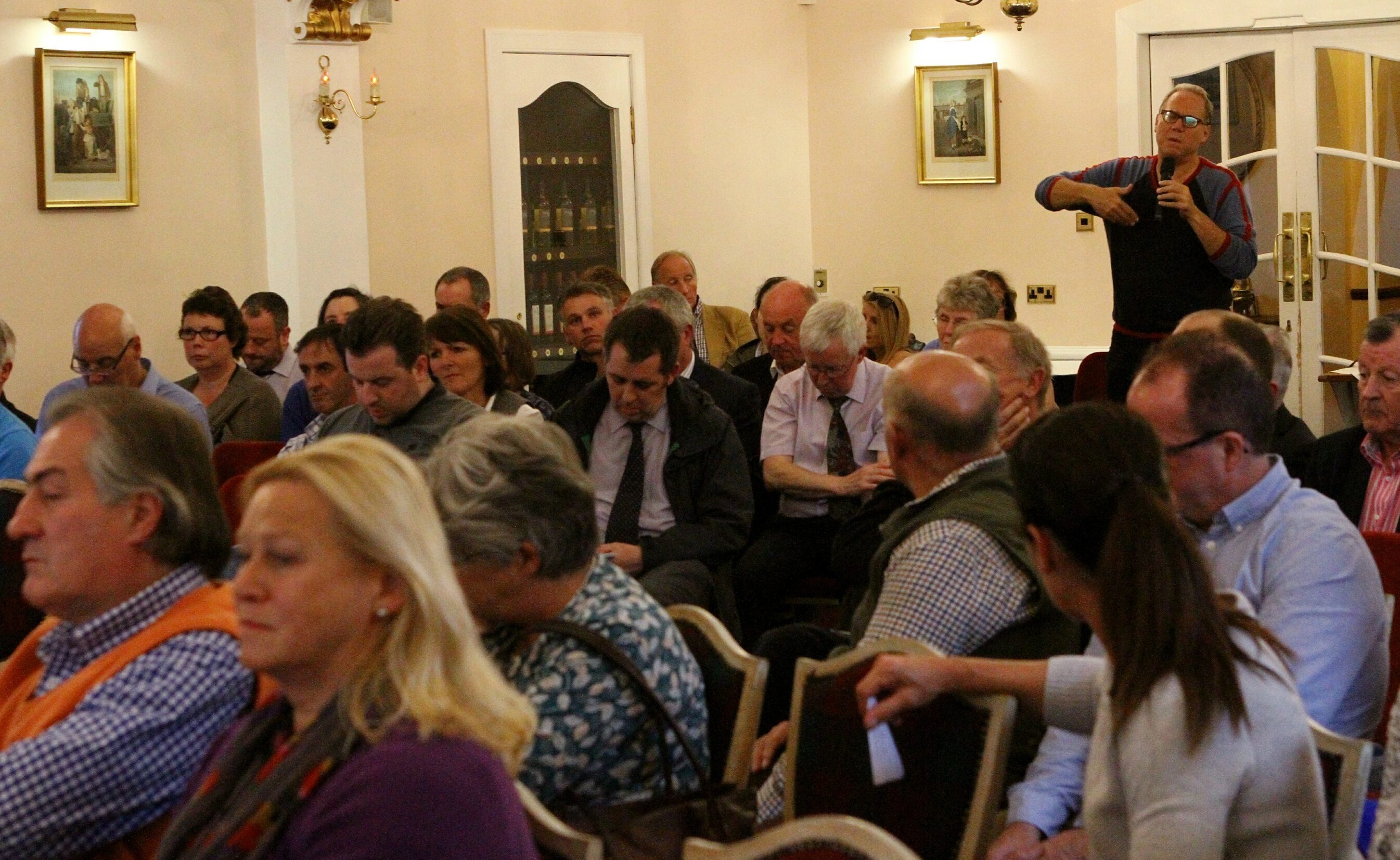 An audience member asks a question of the panel at the business summit