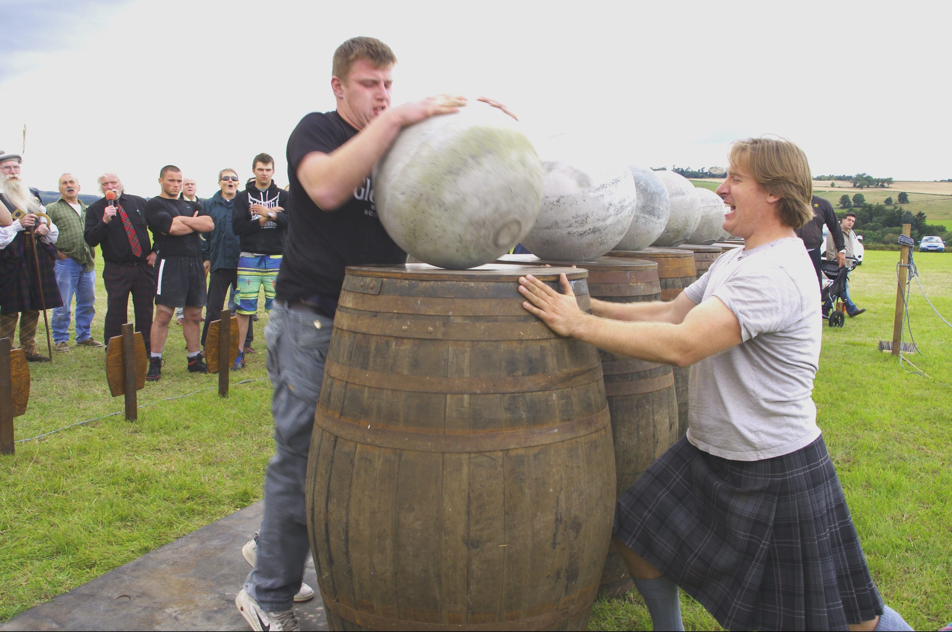 Lorne Colthart lifts the last Ardblair Stone while Charlie Blair Oliphant steadies the barrel at the Blairgowrie Highland Games.