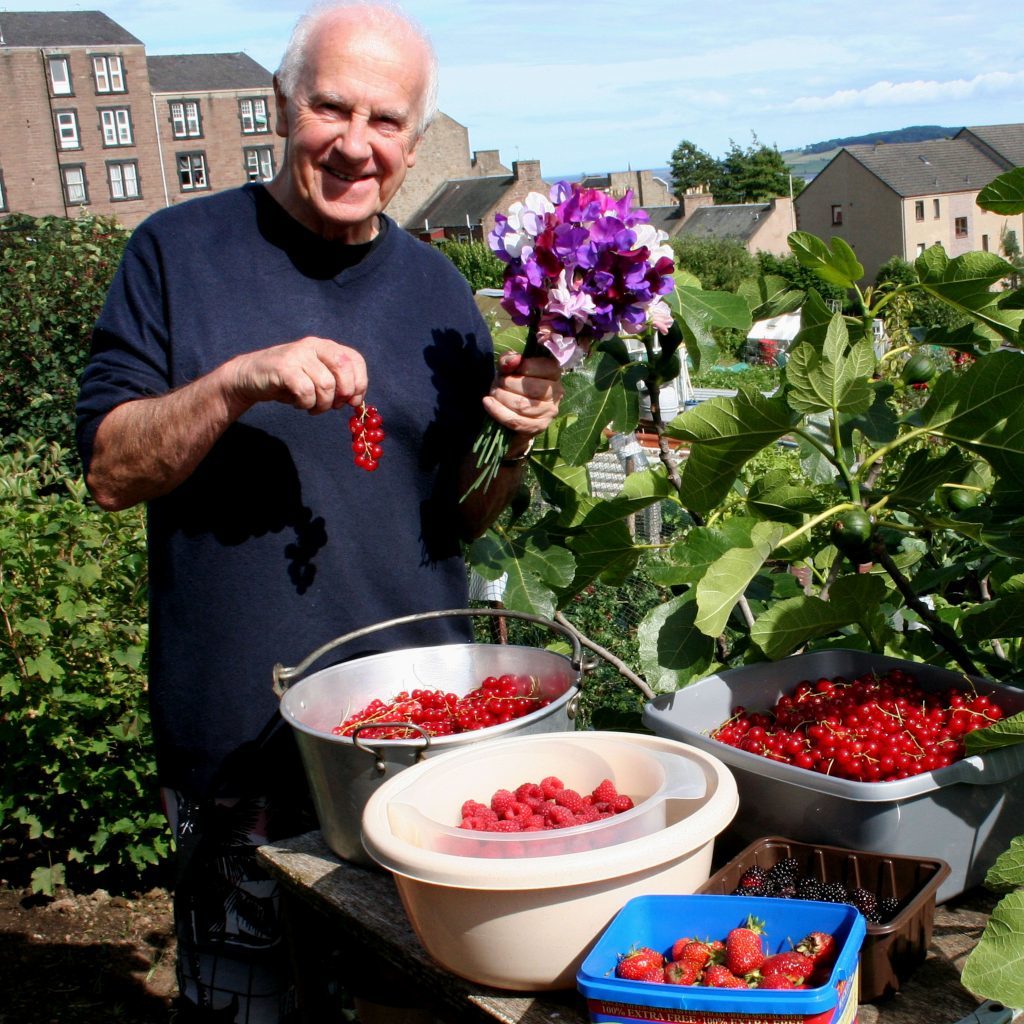 John picks some fruit and flowers