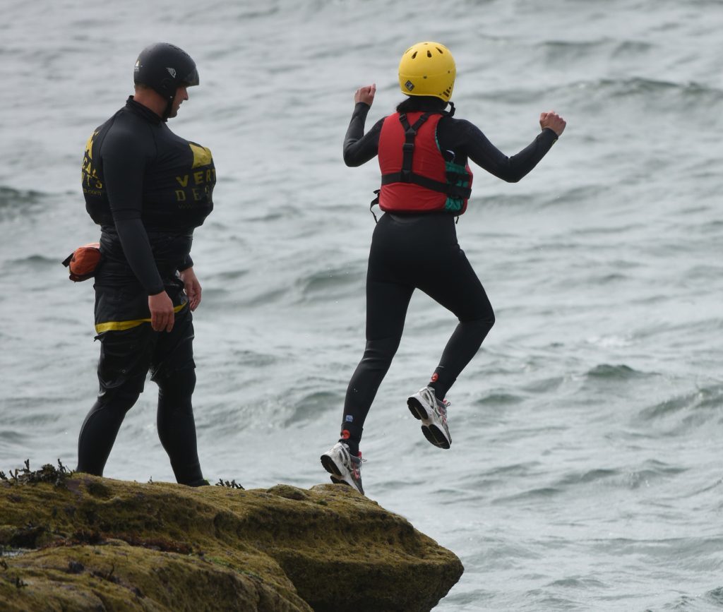 Jumping off Seaton Cliffs under the watchful eye of Olly Baylis.