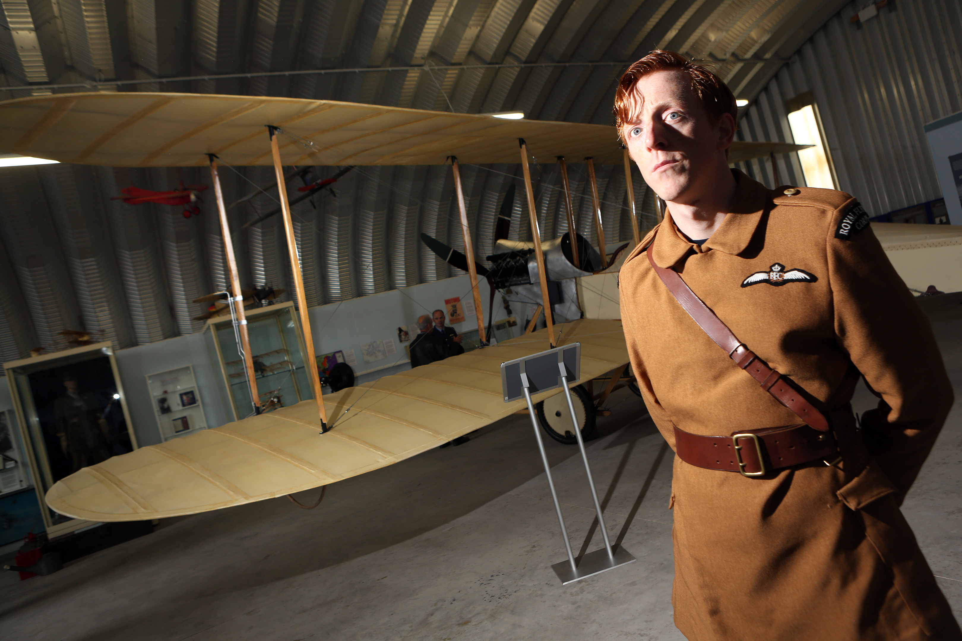 Gavin Wright in period dress beside the plane.