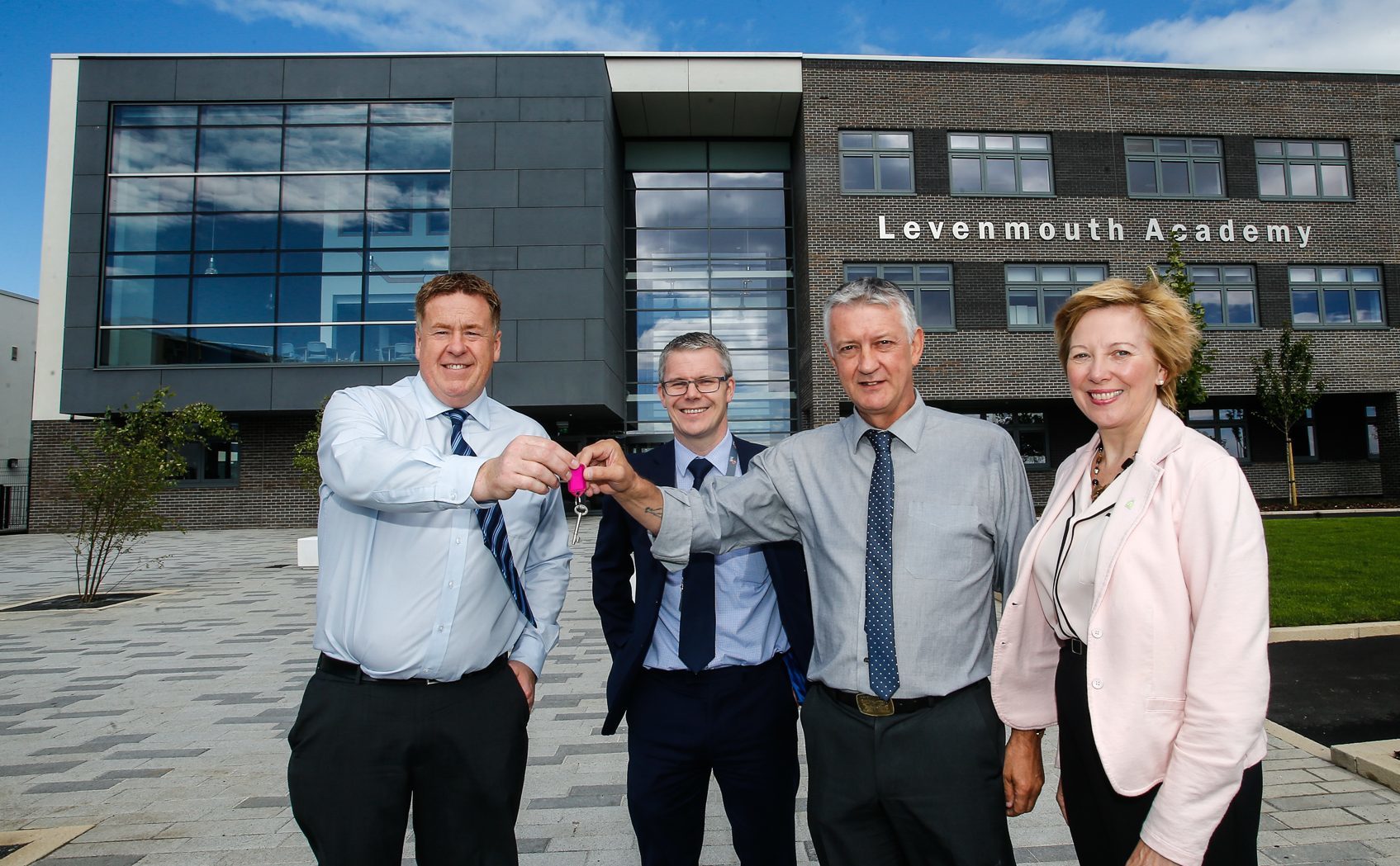 Martin Cooper, of BAM Construction, hands over the keys to Levenmouth Academy to Cllr Tom Adams, chair of the council's Levenmouth area committee and council depute leader Cllr Lesley Laird